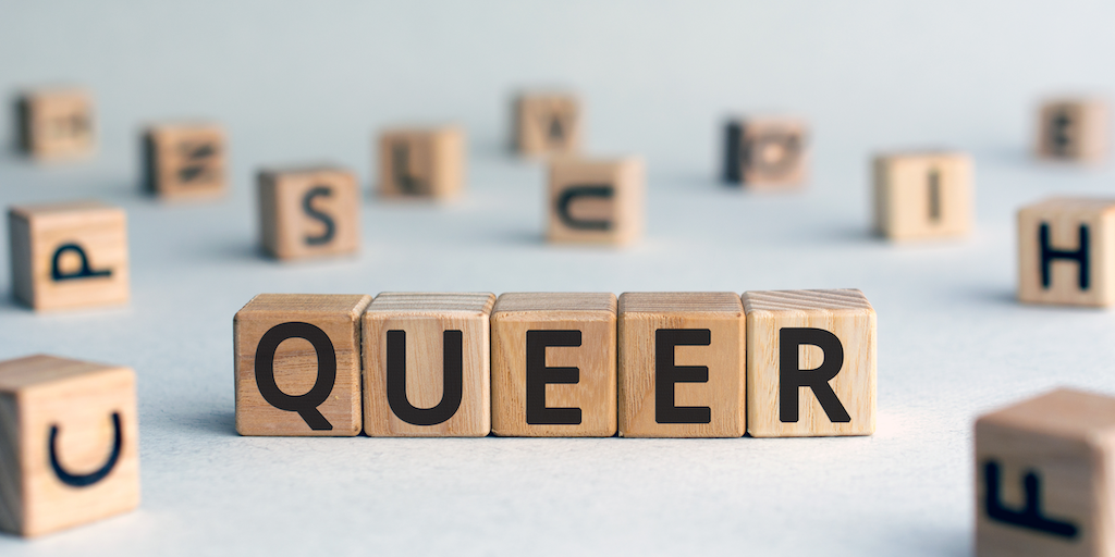 Block letters spelling out 'queer'.